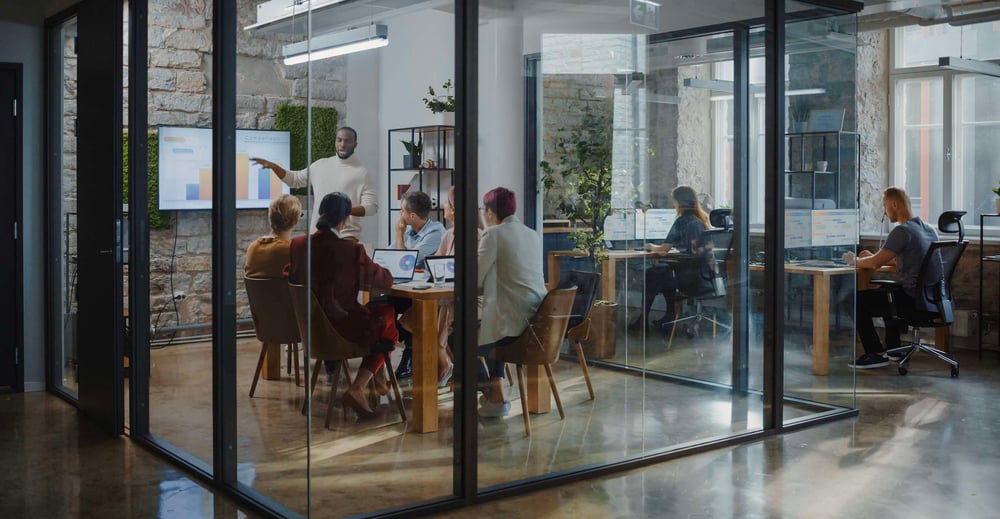 People working in a glass wall office